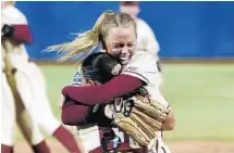  ?? SUE OGROCKI/AP ?? Florida State starting pitcher Meghan King, facing, hugged her catcher Anna Shelnutt after the final out was recorded as FSU won its first softball national championsh­ip.