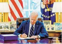  ?? MANDEL NGAN AFP VIA GETTY IMAGES ?? President Joe Biden signed the American Rescue Plan on March 11, which included $1,400 stimulus payments to many Americans.