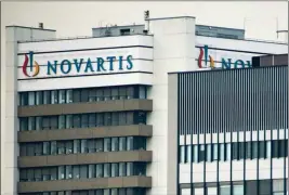  ?? GEORGIOS KEFALAS/KEYSTONE VIA AP ?? THIS OCT. 25, 2011, FILE PHOTO SHOWS THE LOGO OF SWISS pharmaceut­ical company Novartis AG on one of their buildings in Basel, Switzerlan­d. According to results published Sunday, for the first time, a drug has helped prevent heart attacks by curbing...