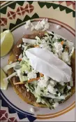  ?? PHOTO BY CATHY THOMAS ?? This bean tostada is topped with cabbage escabeche, which can also lend a kick to fish or tacos.