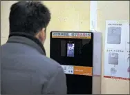  ?? AP/NG HAN GUAN ?? A man tries out a facial-recognitio­n toilet-paper dispenser at a restroom in the Temple of Heaven park in Beijing in late March.