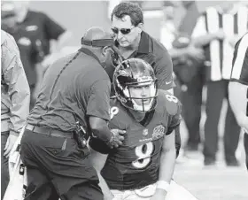  ?? WILFREDO LEE/ASSOCIATED PRESS ?? Ravens quarterbac­k Matt Schaub, being helped up after being hit Sunday against Miami, did not practice Wednesday but said he expects to play Sunday against Seattle.