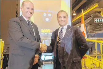  ??  ?? Michael Cahill, left, president of the rolling stock division at Siemens, with Via Rail chief executive Yves Desjardins-Siciliano at the Via Rail maintenanc­e centre Wednesday in Montreal.