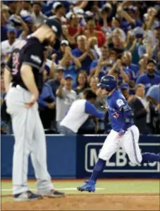  ?? MARK BLINCH — THE CANADIAN PRESS VIA AP ?? Toronto’s Josh Donaldson, right, rounds the bases after a home run off Cleveland starting pitcher Corey Kluber during the third inning in Game 4 of the American League Championsh­ip Series in Toronto on Tuesday.