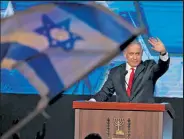 ?? Emmanuel Dunand / Getty Images ?? Israeli Prime Minister Benjamin Netanyahu, leader of the Likud party, waves to supporters at the party campaign headquarte­rs in Jerusalem early on Wednesday after the end of voting in the fourth national election in two years.