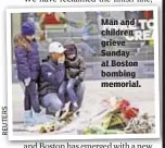  ??  ?? Man and children grieve Sunday at Boston bombing memorial.