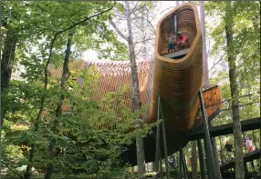  ?? Democrat-Gazette/THOMAS METTHE ?? Josh McGriff of Star City and his son Judd check out the view during the 2018 opening of the tree house at Garvan Woodland Gardens in Hot Springs.
Arkansas