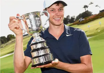  ??  ?? Maiden title: Cameron Davis of Australia holding the trophy after winning the Australian Open yesterday. — AFP