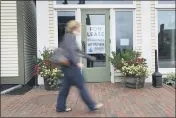  ?? ROBERT F. BUKATY — THE ASSOCIATED PRESS FILE ?? A shopper walks by one of several vacant retail spaces among the outlet shops in Freeport, Maine.