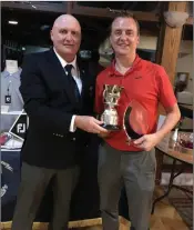  ??  ?? Wicklow Golf Club captain Gerry Doyle presenting Ian Logan with the Golfer of the Year trophy for 2018.