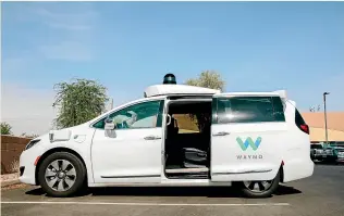  ?? BLOOMBERG ?? A Waymo Chrysler Pacifica autonomous vehicle parked in Chandler, Arizona. The machine will pull over and open a door if police follow it with flashing lights. The office can then talk to someone from the company’s support team.