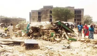  ?? Photo: Mulikatu Mukaila ?? Displaced from their homes, residents rummage through the rubble to find some items buried under the demolition heap at Kado district of Abuja.