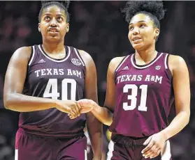  ?? Saul Young / Associated Press ?? Texas A&M’s Ciera Johnson (40) and N'Dea Jones breathe a sigh of relief in the final seconds of the No. 16 Aggies’ 73-71 victory over No. 25 Tennessee on Sunday.