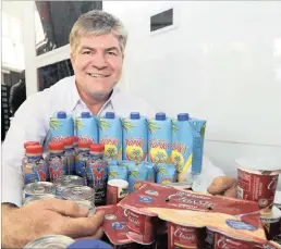  ??  ?? Clover chief executive Johann Vorster posing with Clover products after presenting the company results in Sandton, Johannesbu­rg, yesterday.