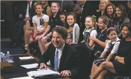  ?? J. SCOTT APPLEWHITE ASSOCIATED PRESS ?? Supreme Court nominee Brett Kavanaugh is joined Thursday by young studentath­letes he has coached as he testifies before the Senate Judiciary Committee on the third day of his confirmati­on hearing on Capitol Hill in Washington.