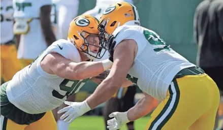  ?? DAN POWERS / USA TODAY NETWORK-WISCONSIN ?? Green Bay Packers defensive tackle Jack Heflin, left, and defensive end Dean Lowry go through drills during camp Wednesday.