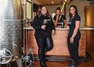  ?? Karen Warren/Staff photograph­er ?? Wine Vibes owners Sheri Lawal Price, Tamesha Hampton and Phelicia Colvin are set to open shop.