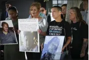  ?? NELVIN C. CEPEDA — THE SAN DIEGO UNION-TRIBUNE ?? Those who lost family members while in custody at the San Diego County Jail hold photos of their love ones during a press conference at the federal courthouse in 2022.