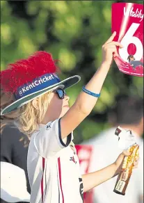  ?? Pictures: Ady Kerry ?? Kent’s Imran Qayyum on his way to figures of 5-21, right, and, above, a young fan enjoys the home team’s big hitting