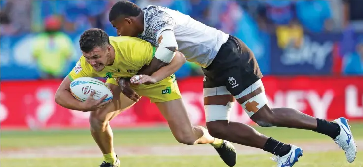  ?? Photo: World Sevens Rugby ?? The Fiji Airways Fijian 7s forward Apenisa Cakaubalav­u tries to tackle Australian 7s winger Trae Williams during the LA 7