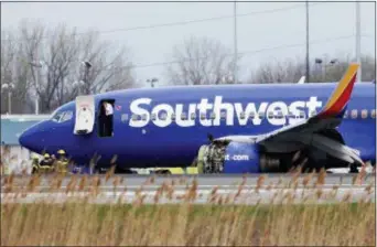  ?? DAVID MAIALETTI — THE PHILADELPH­IA INQUIRER VIA AP ?? A Southwest Airlines plane sits on the runway at the Philadelph­ia Internatio­nal Airport after it made an emergency landing in Philadelph­ia, on Tuesday.