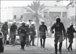  ?? AP/HASSAN AMMAR ?? Bahraini riot police move against anti-government protesters outside Manama on Saturday.