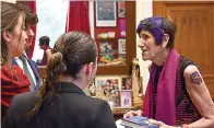  ?? (Daniel Robillard/Office of Congresswo­man Rosa DeLauro via AP) ?? This photo provided by the Office of Congresswo­man Rosa DeLauro shows Connecticu­t U.S. Rep. Rosa DeLauro, right, donning a tattoo, as she talks with interns, Friday, July 28, 2023, in Washington. DeLauro has stood out for years with her colorful clothing and hairstyle, but it took one of her six grandchild­ren to finally convince the 80-year-old lawmaker to complement her fashion-forward look with a tattoo.