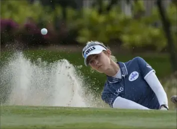  ?? Revecca Blackwell/Associated Press ?? Nelly Korda, one of four players tied for the lead going into the final round of the LPGA Tour Championsh­ip, hits out of a bunker Saturday in Naples, Fla.