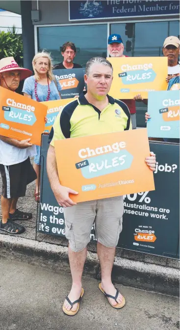  ?? Picture: BRENDAN RADKE ?? NOT HAPPY: A rally outside Leichardt MP Warren Entsch's office protested the growing number of casual jobs in the region. Allan Templeton (centre) had his roster changed.