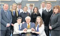  ??  ?? Donation John Gray, president of the Rotary Club of Blairgowri­e, hands over a cheque for £1000 to Grant Williamson, Ailsa Bruce and pupils who will make the trip to Malawi. Also pictured are Ross Marshall, the school’s community link worker, and head...