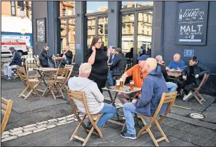  ??  ?? ■ Members of the public enjoy their first drink in a beer garden. (Photo by Jeff J Mitchell/ Getty Images)