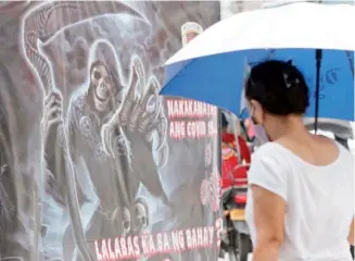  ?? PHOTOGRAPH BY ANALY LABOR FOR THE DAILY TRIBUNE @tribunephl_ana ?? HALLOWEEN is still a month away, but the Pasig local government has posted tarpaulins warning the public on the coronaviru­s disease.