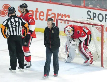  ??  SEAN KILPATRICK/THE CANADIAN PRESS ?? So far, it looks like goaltender Andrew Hammond, seen here after being checked out by the team's athletic therapist Gerry Townend on Monday night against the Sharks, will be good to go on Thursday. Hammond was bumped hard by San Jose's Logan Couture.