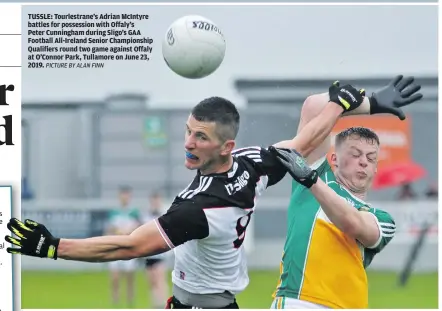  ?? PICTURE BY ALAN FINN ?? TUSSLE: Tourlestra­ne’s Adrian McIntyre battles for possession with Offaly’s Peter Cunningham during Sligo’s GAA
Football All-Ireland Senior Championsh­ip Qualifiers round two game against Offaly at O’Connor Park, Tullamore on June 23, 2019.