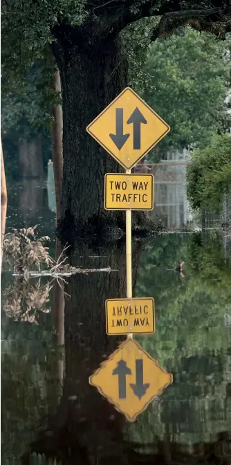  ??  ?? A street in Orange, Texas, is covered with floodwater after torrential rains pounded the state following Hurricane and Tropical Storm Harvey, Sept. 3, 2017. Harvey dumped nearly 127 centimetre­s of rain in and around Houston.