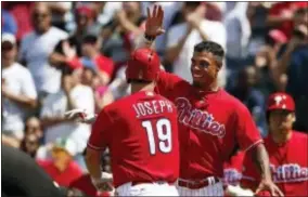  ?? RICH SCHULTZ — THE ASSOCIATED PRESS ?? The Phillies’ Tommy Joseph (19) is congratula­ted by Nick Williams hit a three-run home run during the third inning Thursday. after he