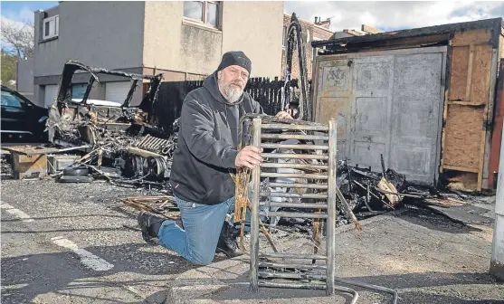  ?? Pictures: Kenny Smith. ?? Caravan owner Robert Love deals with the aftermath of the fire which he estimates caused £25,000 of damage.