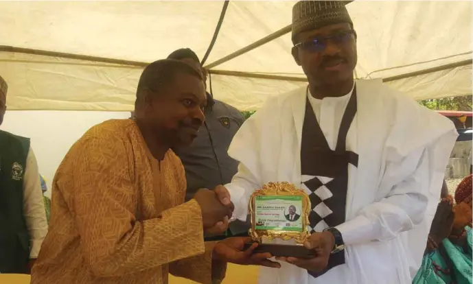  ??  ?? Executive Director of the NPHCDA, Dr Faisal Shuaib presenting the award to to Alhaji Abdul-Ganiyu Adesina Salau