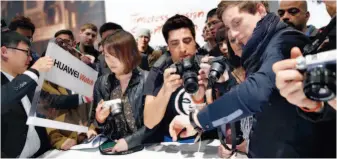  ??  ?? The Chinese telecommun­ication giant Huawei has become a world-leading informatio­n and communicat­ions technology (ICT) solutions provider. The photo shows the company launching its smart watch Huawei Watch and wearable gear Talkband B on March 1, 2015, in Barcelona, Spain. VCG