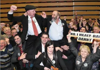  ?? Photo Michelle Cooper Galvin ?? The High Kings of the Kingdom. Michael and Danny Healy-Rae are hoisted aloft by supporters after it is confirmed both had won seats.