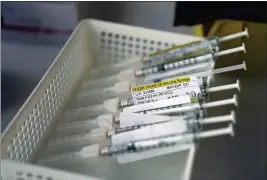  ?? JAE C. HONG — THE ASSOCIATED PRESS FILE ?? Syringes containing the Pfizer-BioNTech COVID-19 vaccine sit in a tray in a vaccinatio­n room at St. Joseph Hospital in Orange on Thursday.