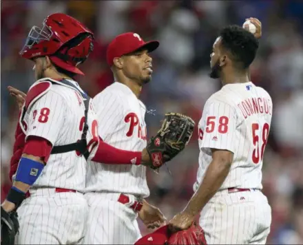  ?? LAURENCE KESTERSON — THE ASSOCIATED PRESS ?? Philadelph­ia Phillies closer Seranthony Dominguez celebrates with teammates following Saturday’s 3-2 win over the Washington Nationals. Dominguez put the finishing touches on a solid outing from the Phillies bullpen once starter Vince Velasquez was forced to leave the game after two innings.