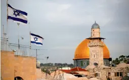  ?? — AFP ?? Israeli flags fly near the Dome of the Rock in the Al- Aqsa mosque compound Tuesday.