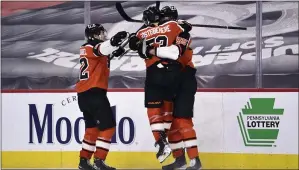  ?? DERIK HAMILTON FOR THE ASSOCIATED PRESS ?? Flyers defenseman Sam Morin, right, celebrates with Shayne Gostisbehe­re and Nicolas AubeKubel, left, after Morin scored a third-period goal Saturday against the Rangers. The Flyers won, 2-1.