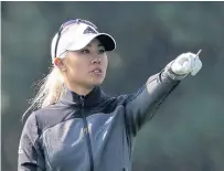  ??  ?? Danielle Kang gestures on the second hole.