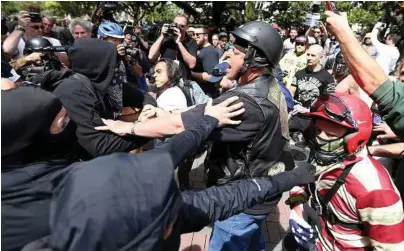  ?? Anda Chu / Bay Area News Group/TNS ?? Anti- and pro-Trump protesters clash during demonstrat­ions in Berkeley, Calif., in April.