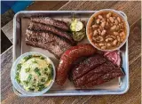  ?? ?? Brisket, jalapeño-cheese sausage, pork ribs, potato salad and beans: Texas’ idea of heaven.