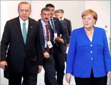  ??  ?? Merkel and Erdogan arrive for a news conference at the chanceller­y in Berlin. — Reuters photo