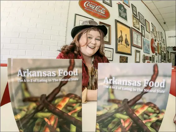  ?? Arkansas Democrat-Gazette/JOHN SYKES JR. ?? Little Rock author Kat Robinson is shown with her latest book, Arkansas Food: The A to Z of Eating in The Natural State.