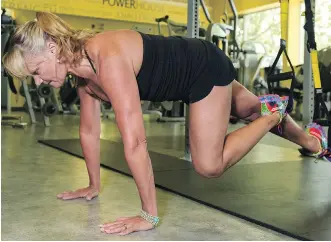  ?? ELIZABETH CAMERON ?? Helen Vanderburg demonstrat­es TRX moves at Heavens Fitness in Calgary.